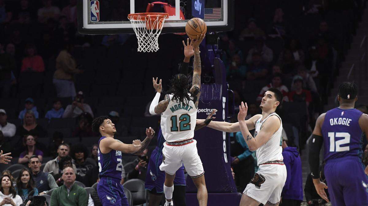 Memphis Grizzlies guard Ja Morant (12) drives in during the first half against the Charlotte Hornets at the Spectrum Center.