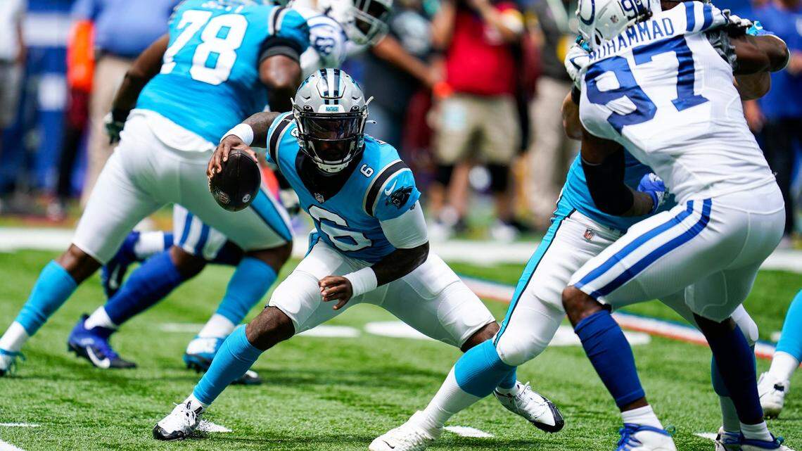 Carolina Panthers quarterback P.J. Walker (6) is chased from the pocket by Indianapolis Colts defensive end Al-Quadin Muhammad (97) during the first half of an NFL exhibition football game in Indianapolis Sunday. The Colts won, 21-18.