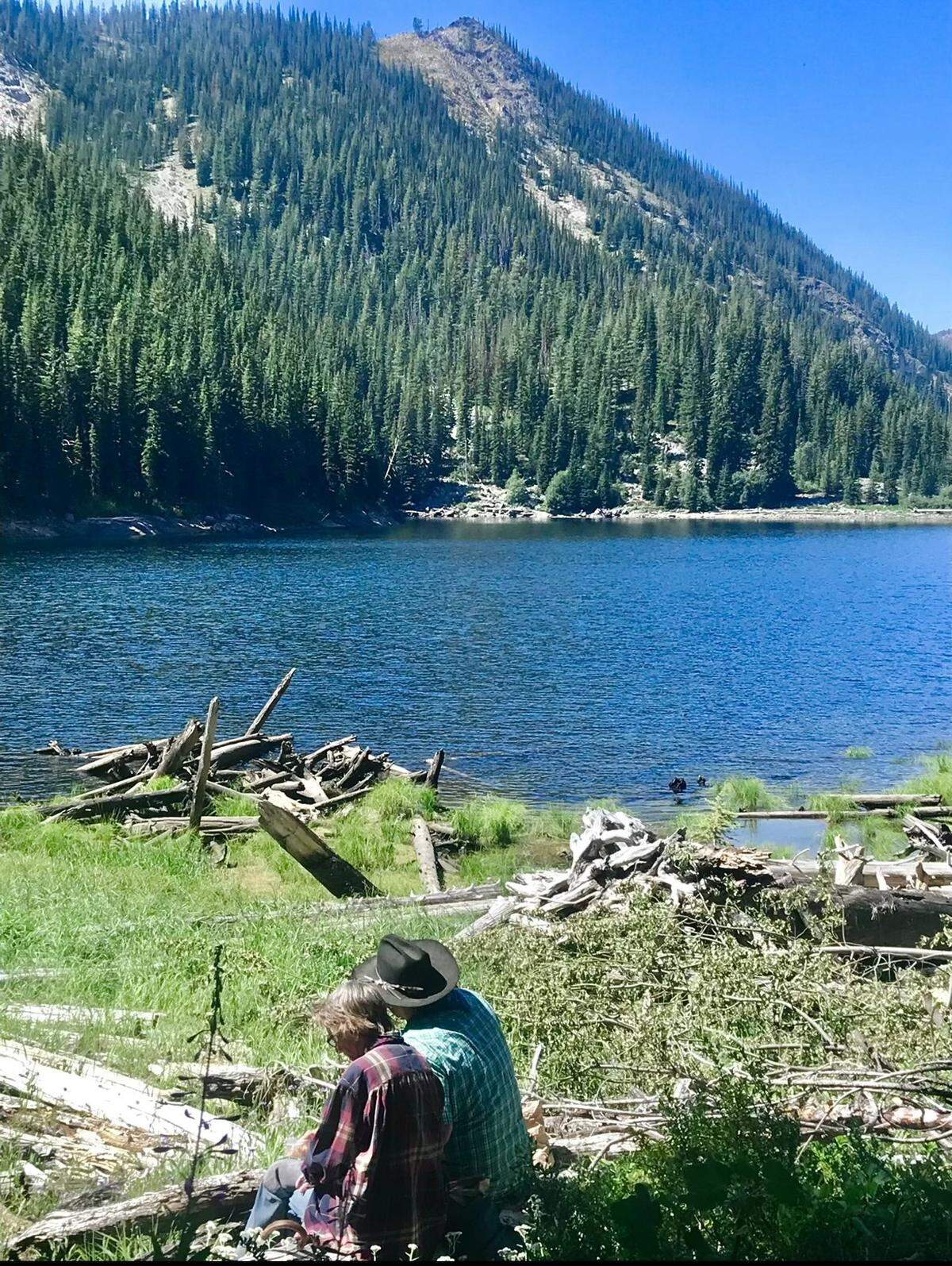 Daniel Knox and Anne Springs Close at Cub Lake in Washington State. Knox was 43 and Close was 93, and it was their final hike together. Close was nearly blind, and this photo shows Knox describing the lake to her in detail.