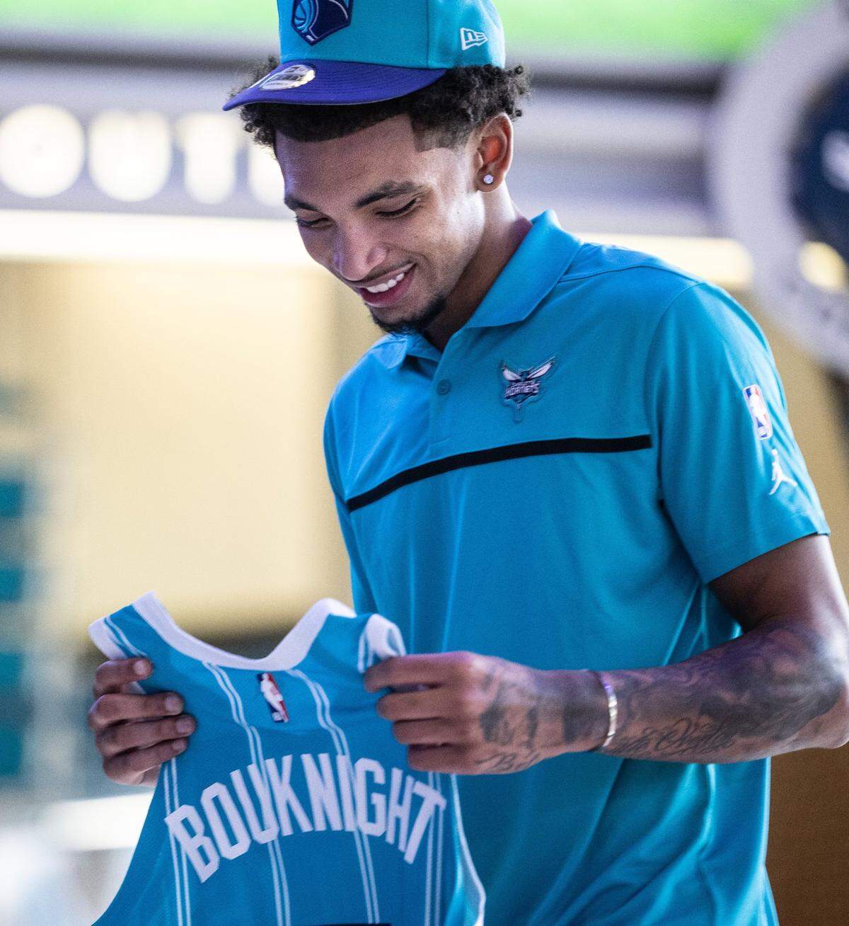 Charlotte Hornets draft pick James Bouknight holds his new jersey during a press conference at the Spectrum Center in Charlotte, N.C., on Friday, July 30, 2021.