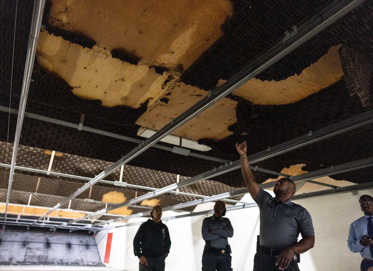 Sgt. C. Anderson points out leaking water from ceiling and sound insulation that is damaged in Firing Range B at the Mecklenburg County Sheriffs Office Training Academy in Charlotte, N.C., on Thursday, June 8, 2023.