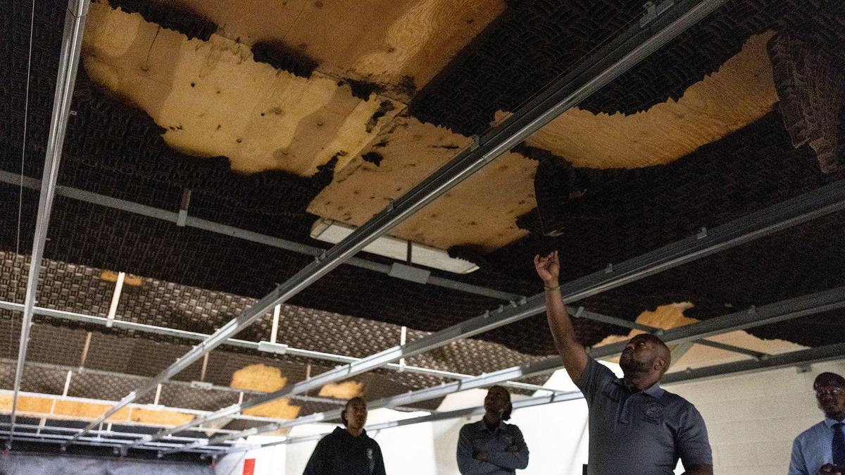 Sgt. C. Anderson points out leaking water from ceiling and sound insulation that is damaged in Firing Range B at the Mecklenburg County Sheriffs Office Training Academy in Charlotte, N.C., on Thursday, June 8, 2023.