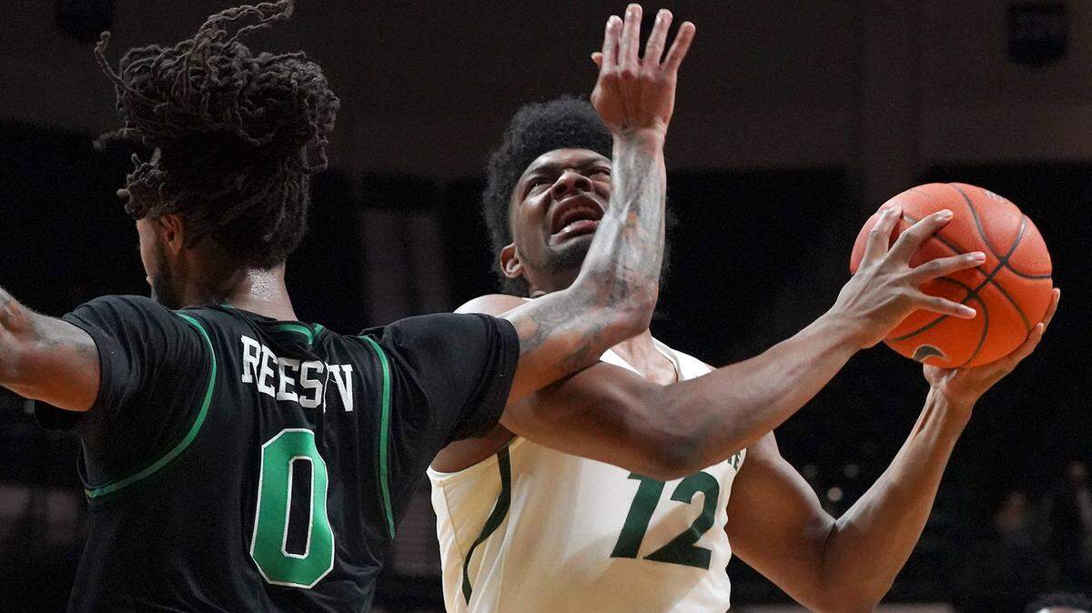 Charlotte 49ers guard Malik Martin (12) goes to the basket against North Texas’ James Reese.