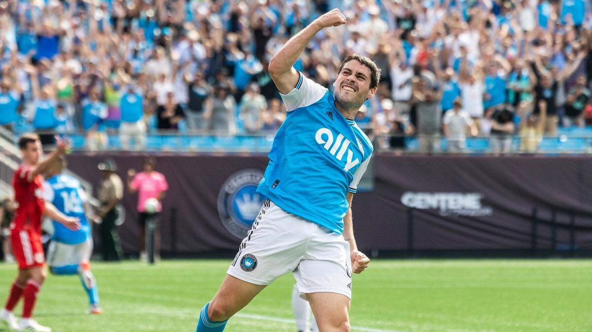 Charlotte FC midfielder Sergio Ruiz throws his fist in the air to celebrate after he assisted on a goal by Derrick Jones during the game against the New York Red Bulls at Bank of America Stadium on Saturday. Charlotte FC defeated the Red Bulls 2-0.