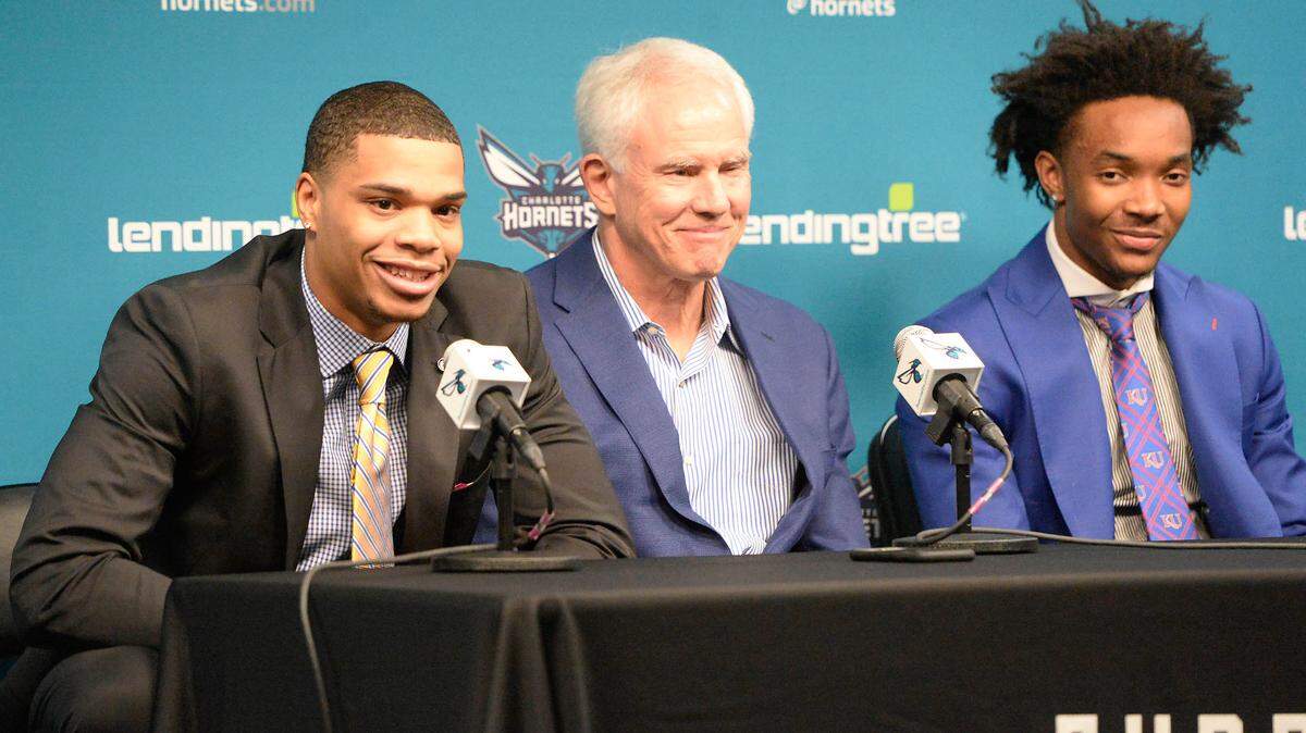 Charlotte Hornets first and second round draft picks Miles Bridges, left, and Devonte’ Graham, right, answer questions from the media as they sit with President of Basketball Operations & General Manager Mitch Kupchak during their introductory news conference at Spectrum Center in Charlotte, N.C., on Friday, June 22, 2018. (David T. Foster III/Charlotte Observer/TNS)