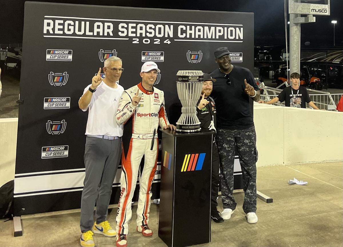 23XI Racing’s Curtis Polk, Denny Hamlin, Tyler Reddick and Michael Jordan celebrate Reddick winning the 2024 NASCAR Cup Series regular season championship in Darlington, S.C.