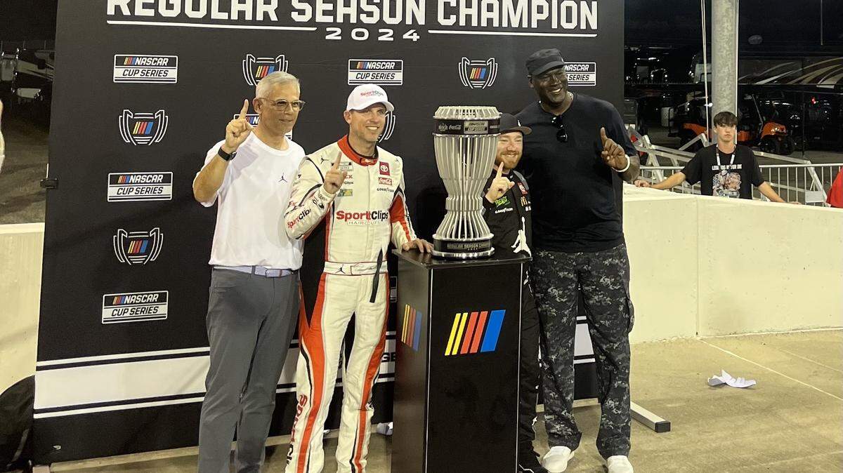 23XI Racing’s Curtis Polk, Denny Hamlin, Tyler Reddick and Michael Jordan celebrate Reddick winning the 2024 NASCAR Cup Series regular season championship in Darlington, S.C.