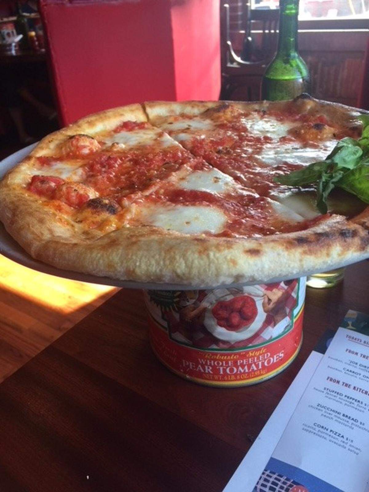 At Benny’s, the pizzas are placed on used tomato cans.