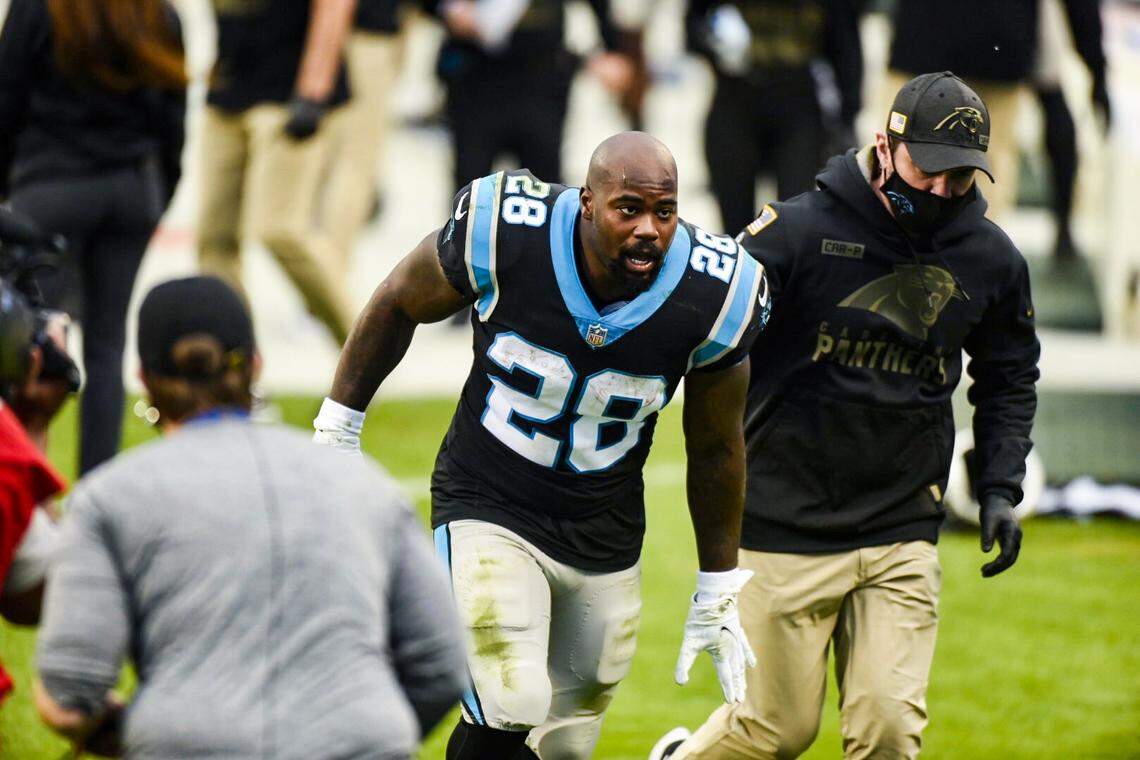 Mike Davis runs off the field with an injured left hand during third quarter action against the Tampa Bay Buccaneers at Bank of America Stadium in Charlotte, NC on Sunday, November 15, 2020.