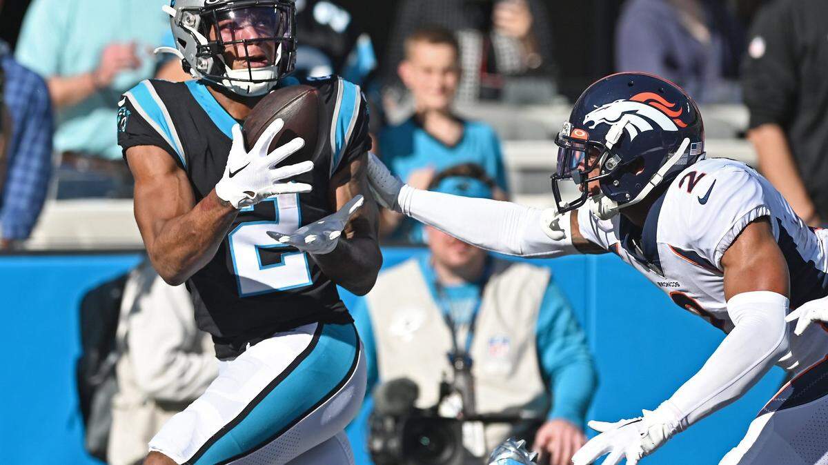 Carolina Panthers wide receiver DJ Moore, left, catches a touchdown pass in front of Denver Broncos cornerback Pat Surtain, right, during first quarter action Sunday, November 27, 2022 at Bank of America Stadium in Charlotte, NC.