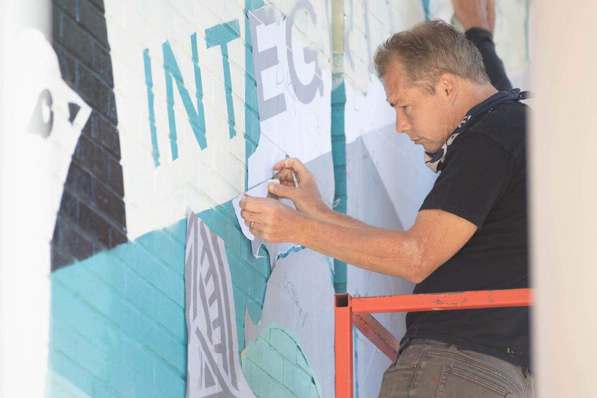 Shepard Fairey paints at Queens University of Charlotte on Thursday, Oct. 21.