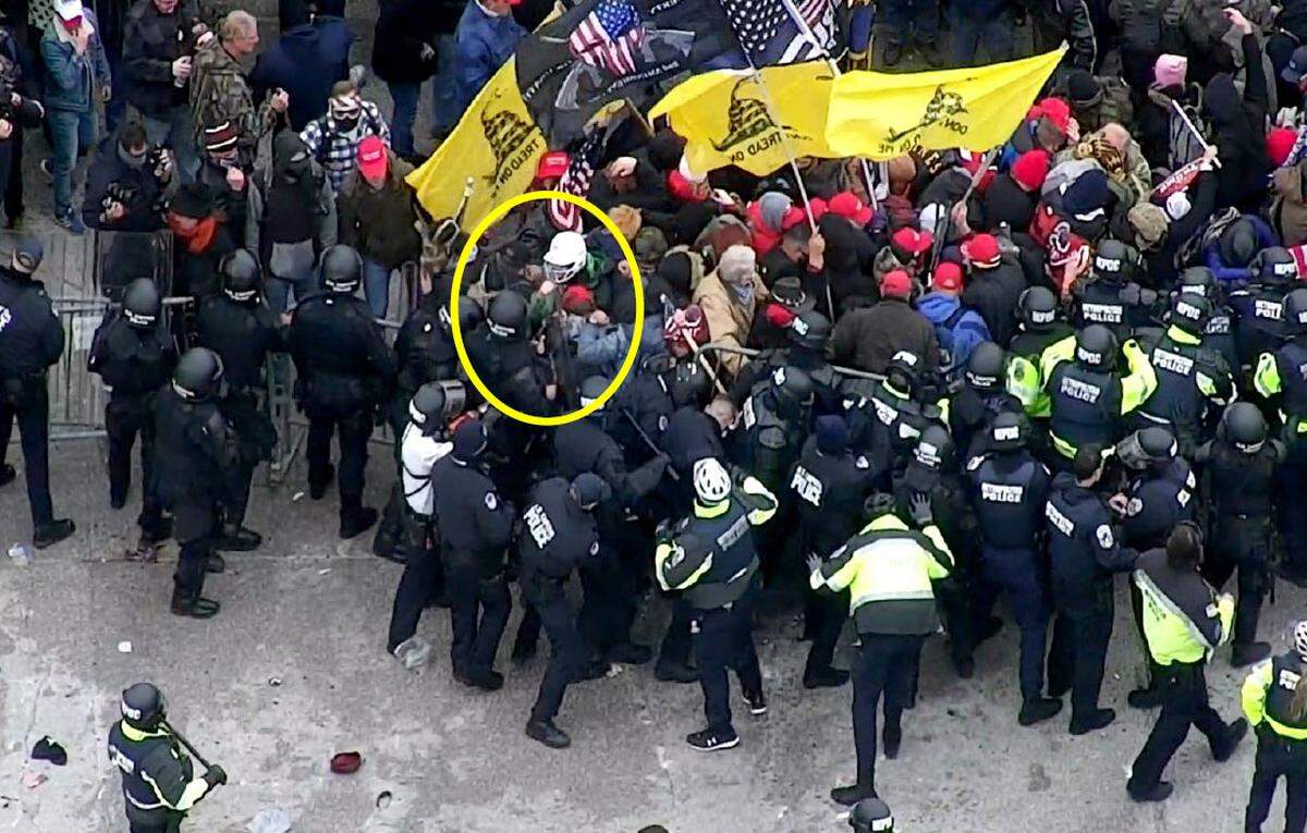 David Gietzen, 38, of Sanford, wearing a white helmet, battled police outside the U.S. Capitol on Jan. 6, 2021. He was arrested this month charged with eight crimes. The FBI says it received a report that Gietzen and his brother planned to return to Washington on Inauguration Day to again storm the Capitol. FBI photo.