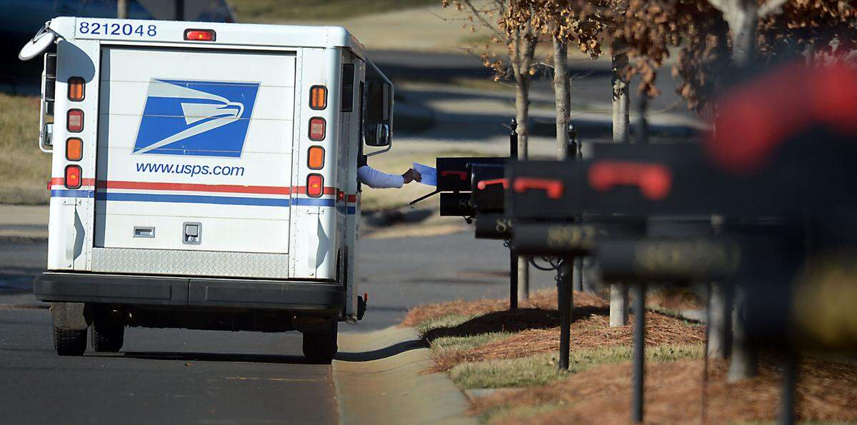 A postal worker delivers mail on Carneros Creek Road in west Charlotte.