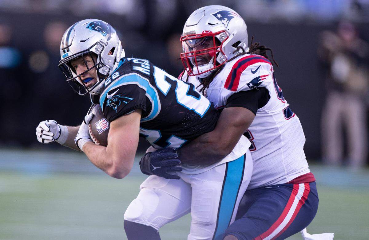 Carolina Panthers Christian McCaffrey, left, is tackled by New England Patriots Donta Hightower at the Bank of America Stadium in Charlotte, N.C., on Sunday, November 7, 2021.