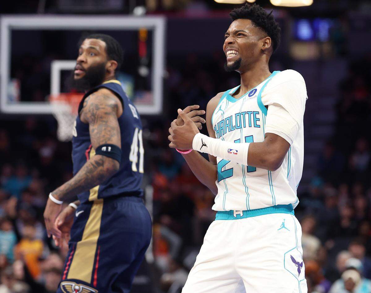 Charlotte Hornets guard Brandon Miller, right, holds his right hand after being hit by New Orleans Pelicans forward Saddiq Bey, left, during action at Spectrum Center in Charlotte, NC on Monday, Feb. 2, 2026. 