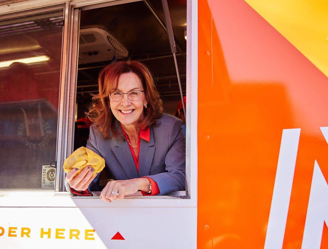 Whataburger President and CEO Debbie Stroud peeks out of the Whataburger food truck at the first Hickory restaurant’s groundbreaking celebration. Stroud has strong ties to North Carolina and raised her children in the Raleigh area before taking over at the Texas-based chain.