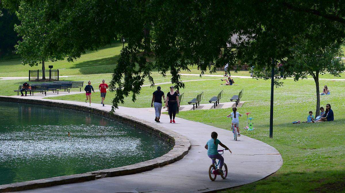 People enjoy activities along the lake at Freedom Park on Wednesday, May 6, 2020.