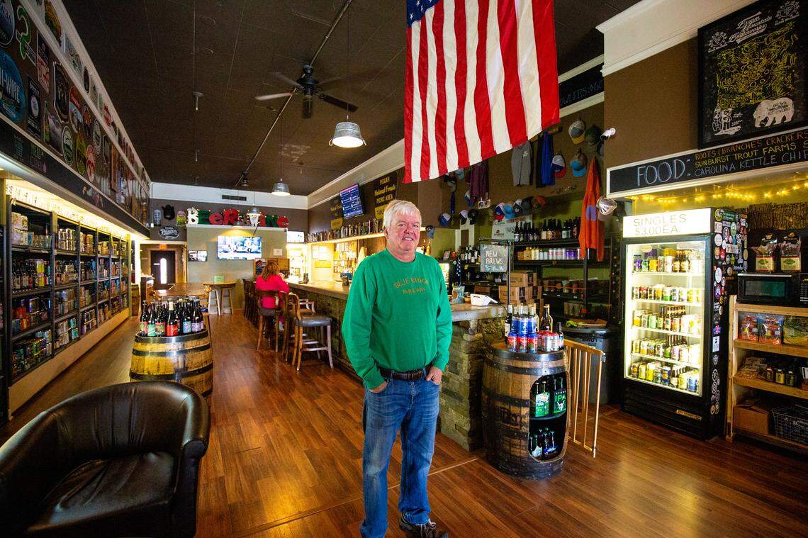 Mike Brown, owner of Brown Mountain Bottleworks, stands for a portrait. Business like these have opened rapidly in downtown Morganton in the past five years as the economy bounces back from losing a large portion of the textile industry.