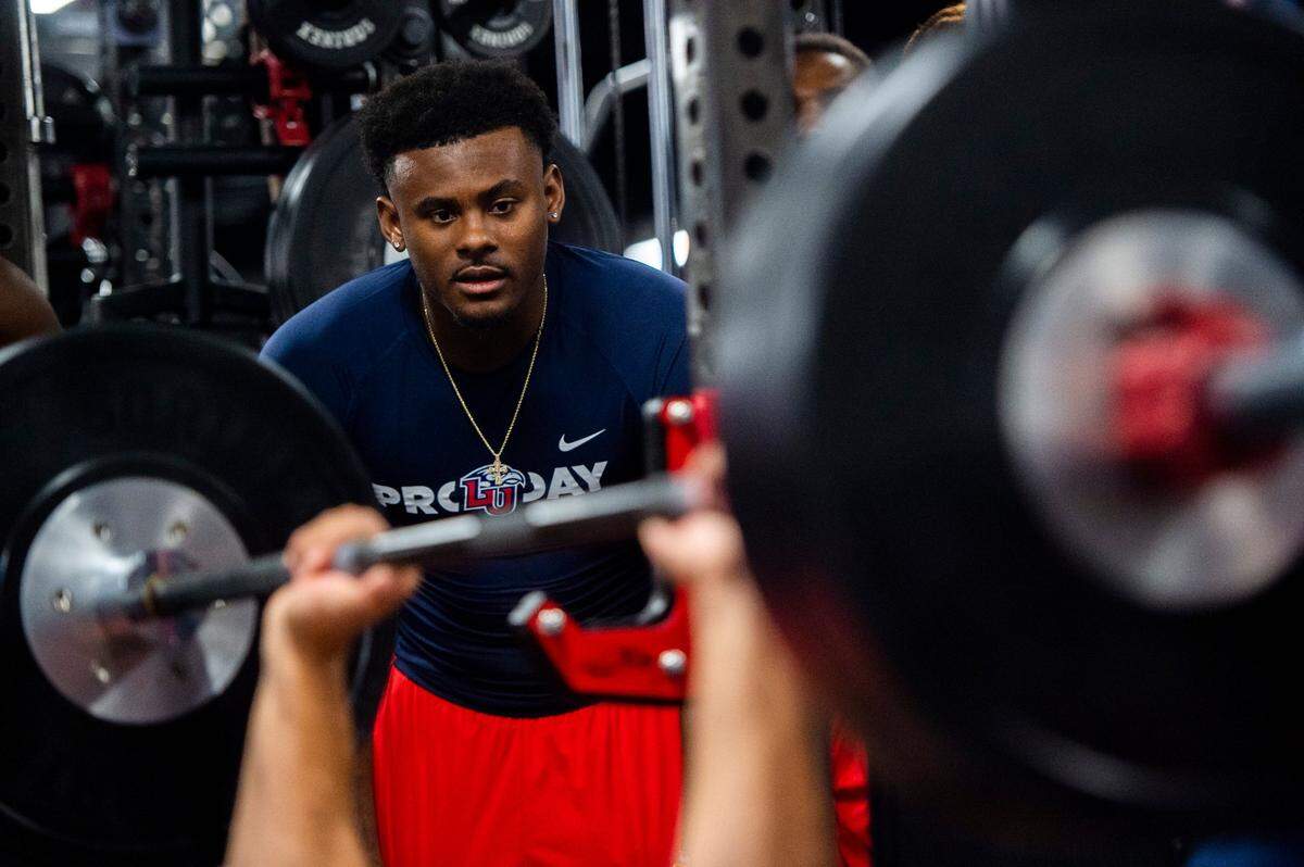 Malik Willis supports teammates participating in Liberty football Pro Day in Lynchburg, Va., Tuesday, March 22, 2022. (AP Photo/Kendall Warner)