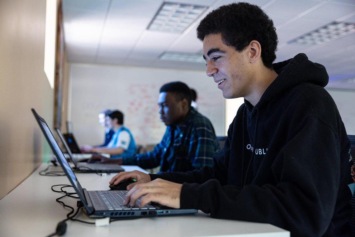 Kaliek Wade sits a gaming laptop for a portrait at Stiegler Edtech in Charlotte, N.C., on Wednesday, November 23, 2022.
