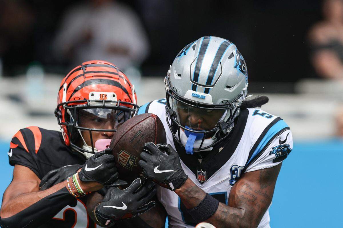 Panthers wide receiver Diontae Johnson, right, vies for the ball with Bengals cornerback DJ Tuner II during the game against the Bengals at Bank of America stadium in Charlotte, NC on Sunday, September 29, 2024.