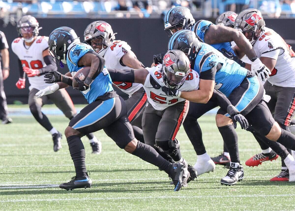 Carolina Panthers running back Trevor Etienne carries the ball as Tampa Bay Buccaneers defenders close in during the game at Bank of America Stadium on Sunday, Oct. 25, 2026 in Charlotte.