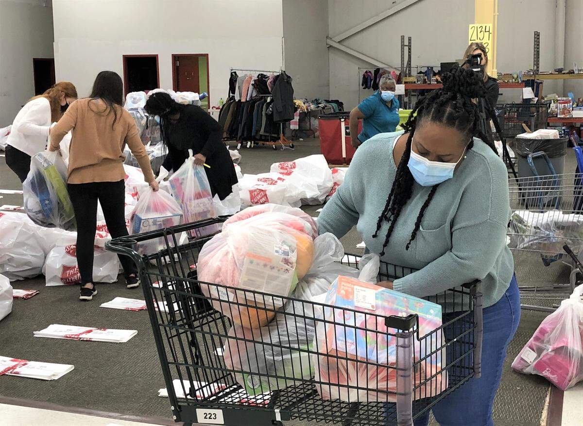 Staff and volunteers handle gifts for the Salvation Army of Greater Charlotte’s angel tree program.