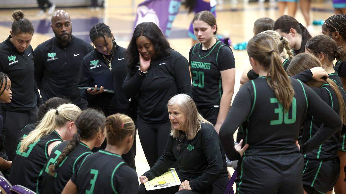 Myers Park head coach Barbara Nelson, center, speaks to her team during a timeout against the Palisades Pumas. Nelson and her team won her 800th career game 58-44 on Tuesday, January 28, 2025 at Palisades High School.