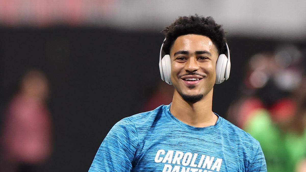 Carolina Panthers quarterback Bryce Young smiles as he throws passes during a pregame workout at Mercedes-Benz Stadium in Atlanta on September 10, 2023.