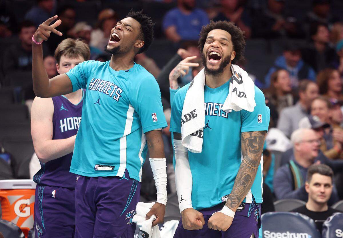Charlotte Hornets guard Brandon Miller, left, and forward Miles Bridges, right, celebrate the team’s play during action against the Philadelphia 76ers at Spectrum Center in Charlotte, North Carolina, on Monday, Jan. 26, 2026.
