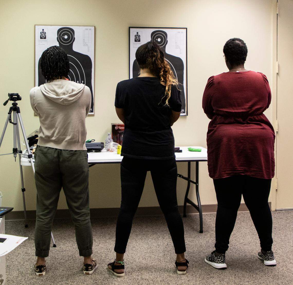 LaToya Workman and her two students practice aiming at targets in Charlotte, NC Saturday August 13, 2022.