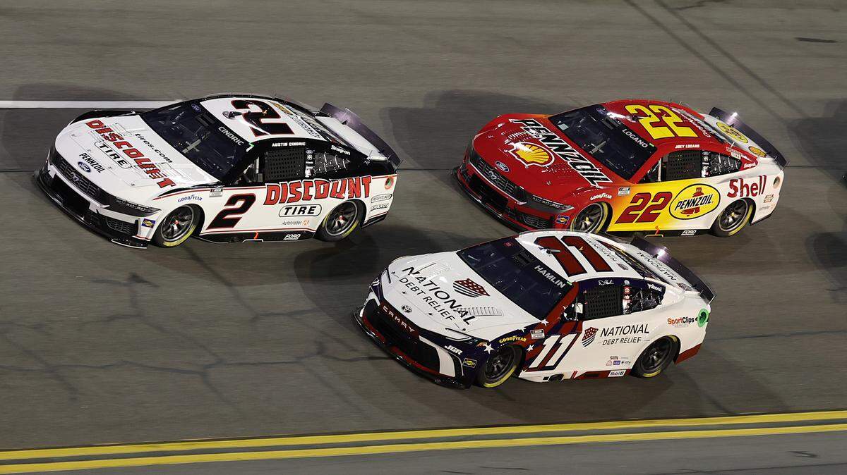 Feb 13, 2025; Daytona Beach, Florida, USA; NASCAR Cup Series driver Austin Cindric (2) leads driver Denny Hamlin (11) during Duel 2 at Daytona International Speedway. Mandatory Credit: Mike Watters-Imagn Images