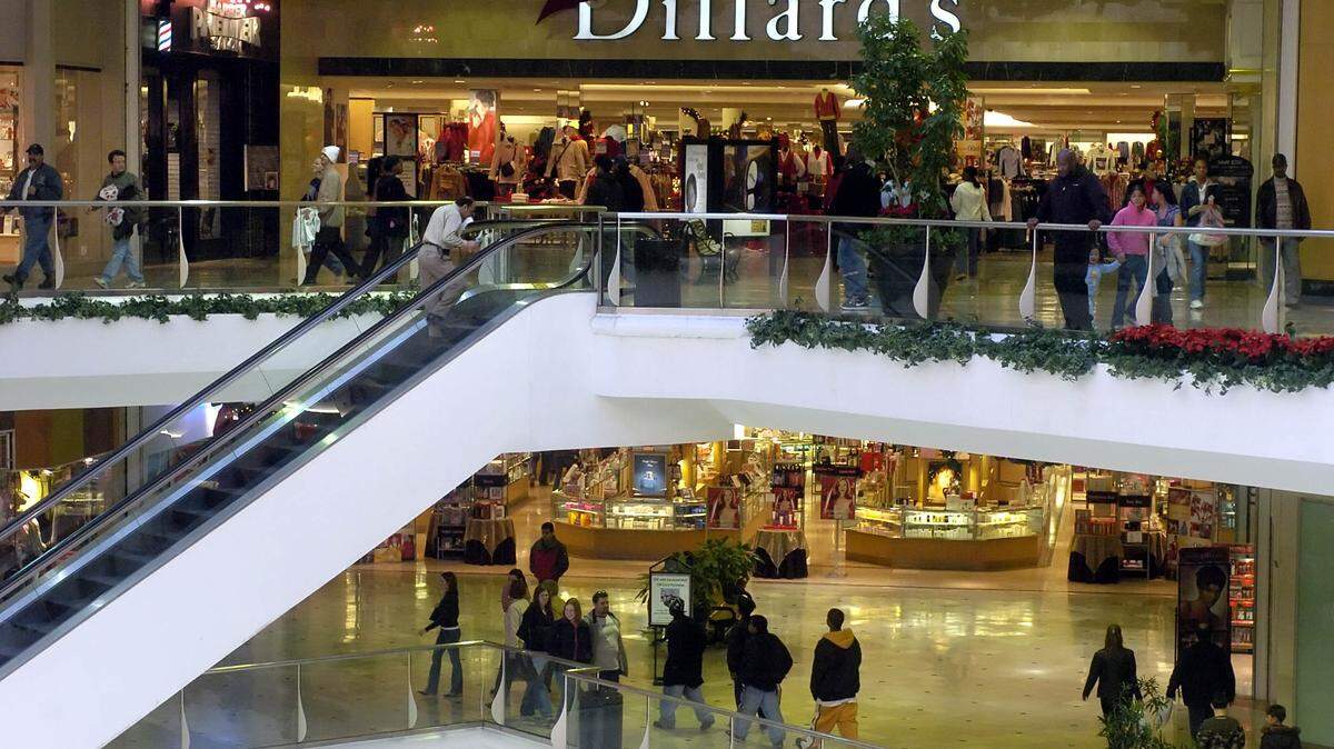 In this December 2004 file photo, shoppers at Eastland Mall walk along both levels of the mall, continuing to to shop, in the days before Christmas. DAVID T. FOSTER III-STAFF




