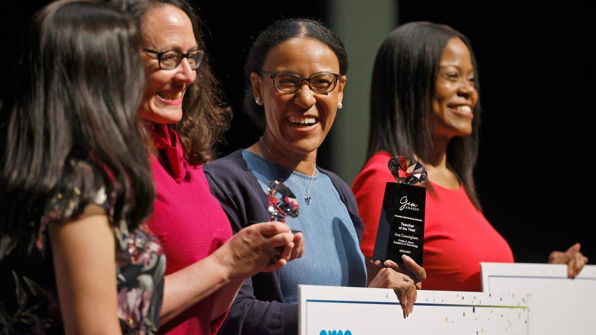 Phillip O. Berry, Academy of Technology teacher Ana Cunningham, center, smiles after being announced as Charlotte Mecklenburg School teacher of the year.
