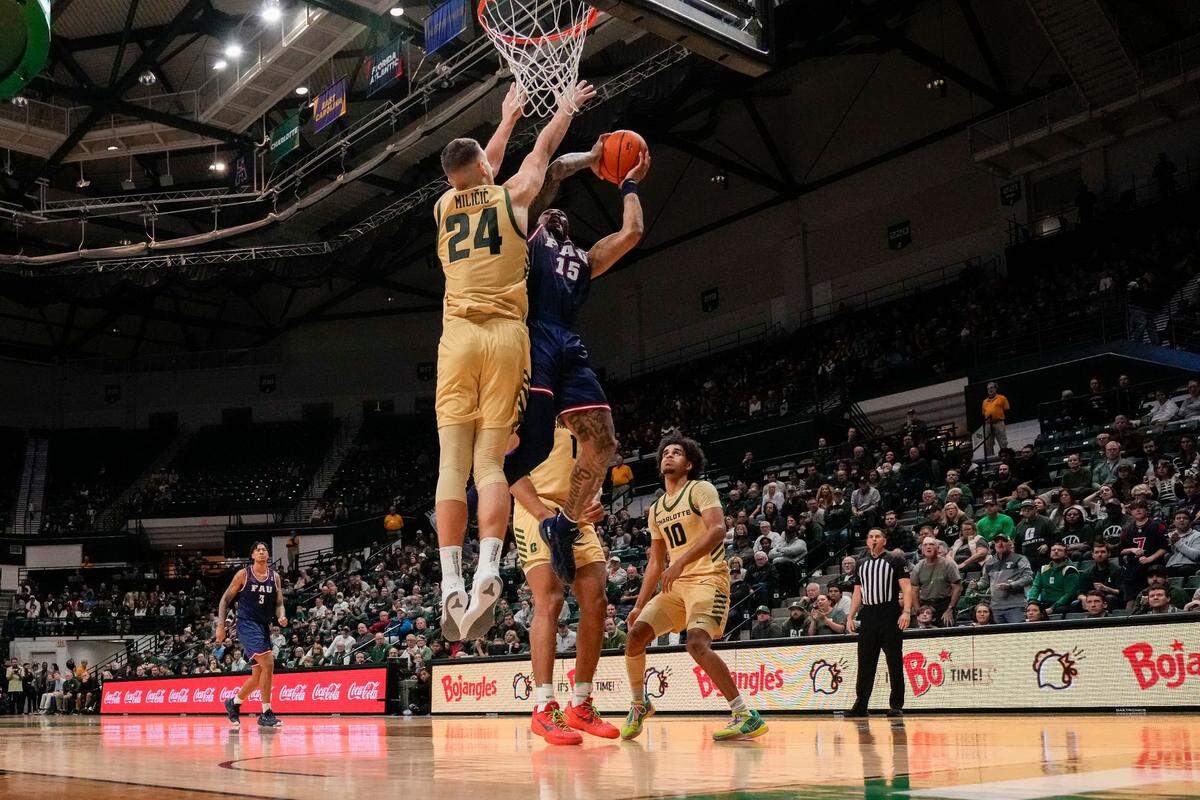 Igor Milicic Jr. (24) blocks a shot by Florida Atlantic Owls guard Alijah Martin (15) during the second half on Jan. 6 at Dale F. Halton Arena in Charlotte.