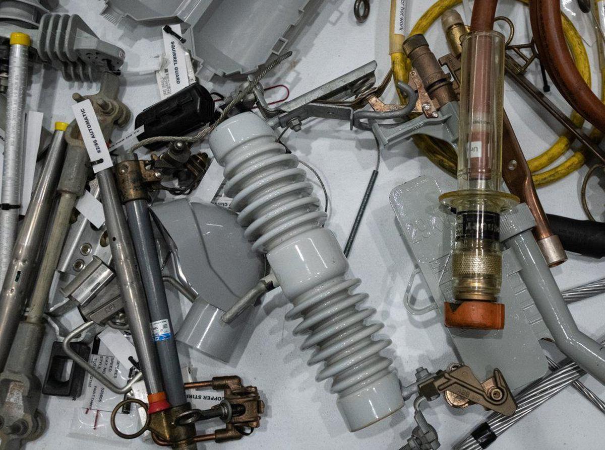 Various electrical cables, pipes, and components sit atop a small table for training new technicians inside Duke Energy’s Distribution Control Center in Charlotte, North Carolina on Wednesday morning, June 8, 2022. Employees at their desks field calls from customers, divert power, and dispatch service technician teams to the field for maintenance and repairs.