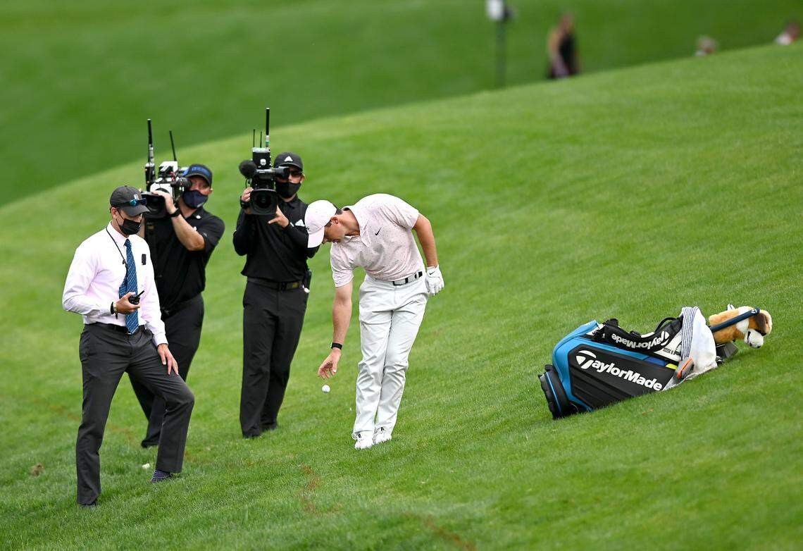 Golfer Rory McIlroy drops a ball along the 18th fairway during the final round of the Wells Fargo Championship at Quail Hollow Club in Charlotte, NC on Sunday, May 9, 2021. McIlroy took a penalty when his ball went into the stream area on the play and had to drop a ball. McIlroy scored a 68 on the round and finished at -10.