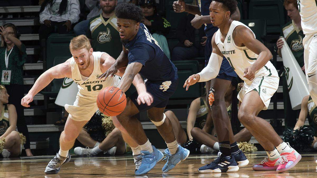 The Charlotte 49ers’ Cooper Robb (10) and Jahmir Young (1) go for a steal against Florida International.