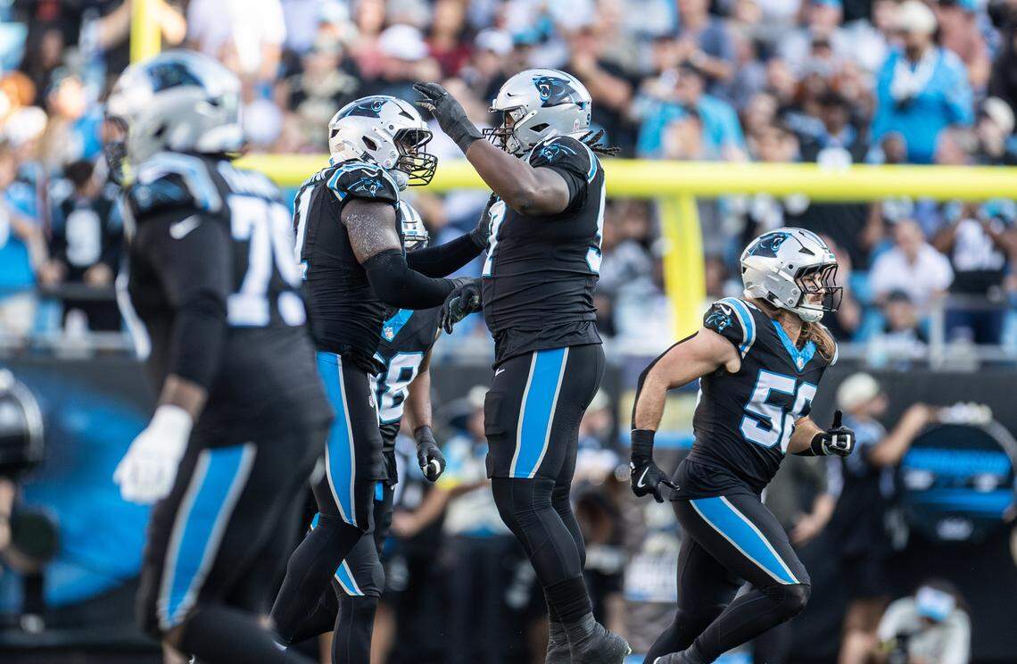 Carolina Panthers linebacker Nic Scourton, left, celebrates with Carolina Panthers defensive tackle Bobby Brown III on Nov. 9, 2025, at Bank of America Stadium.