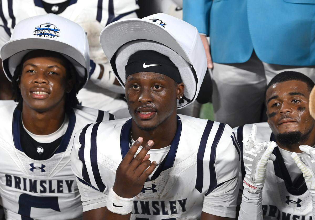 Grimsley Whirlies quarterback Faizon Brandon, center, led the team to a 28-27 win over the West Charlotte Lions in the Keep Pounding Classic at Bank of America Stadium on Friday, August 22, 2025.