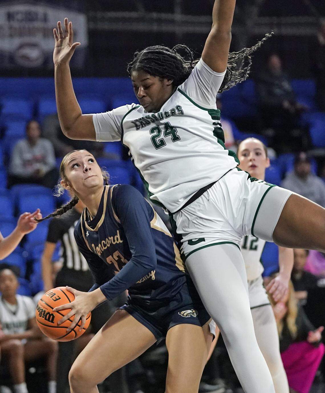 Concord Academy's Justice Alexander, left, gets fouled by Grace Christian's Kyndoll English as she goes for a shot during the first half of their N.C. Independent Schools Athletic Association 3A girls state championship game Friday, Feb. 27, 2026, in Greensboro, N.C. (Credit: Bill Kiser/Special to the Charlotte Observer)