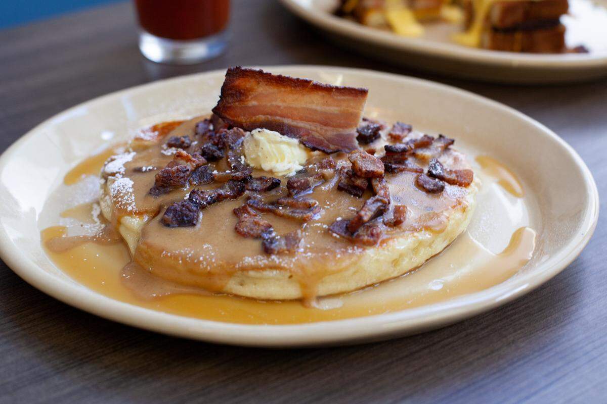 Snooze takes its pancakes up a notch with Tender Belly bacon crumble.
