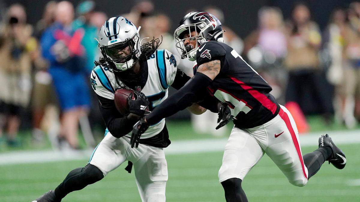 Carolina Panthers cornerback Donte Jackson, left, intercepts a pass intended for Atlanta Falcons wide receiver Damiere Byrd, right, during the first half of an NFL football game Sunday, Oct. 30, 2022, in Atlanta. (AP Photo/John Bazemore)