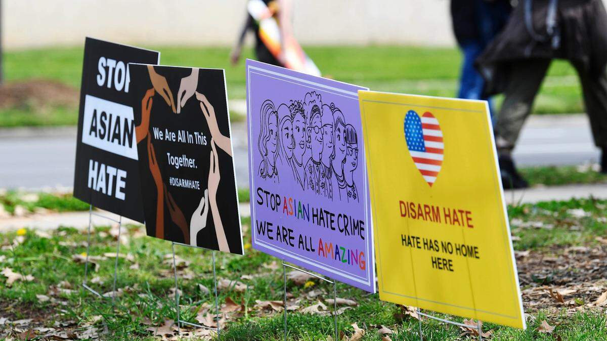 Marchers walk past signs at the end of the Stop Asian Hate rally at Marshall Park in Charlotte on Saturday, March 27, 2021. The event was sponsored by AAPI-NC and the Charlotte-Mecklenburg branch of the NAACP.
