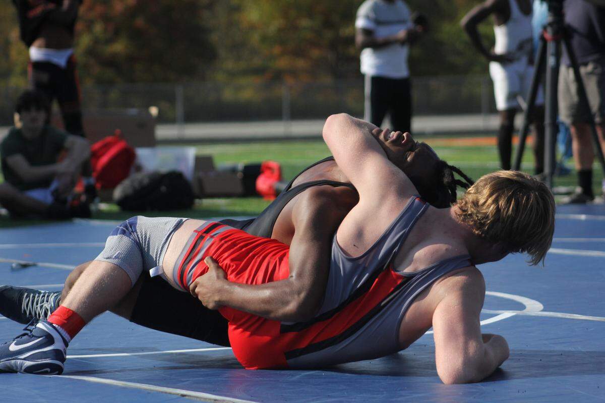 Title: East Meck Wrestling Undefeated varsity wrestler Cole Kenerly takes down his opponent. October 26, 2024 at the “Gridiron Grapple”.