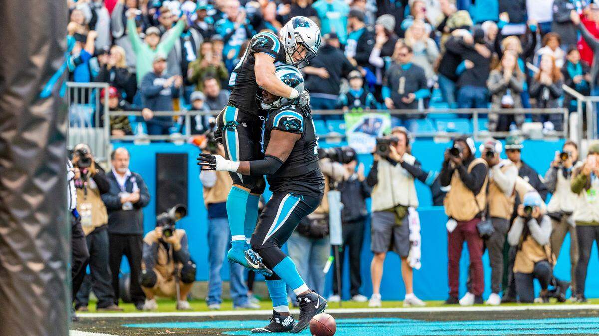 Carolina Panthers running back Christian McCaffrey (22) and teammate Carolina Panthers offensive guard Marshall Newhouse (71) celebrate a touchdown against the Seattle Seahawks during an NFL football game between the Seattle Seahawks and the Carolina Panthers, Sunday, Nov. 25, 2018 in Charlotte, N.C. (Photo by Chris Keane/AP Images for Panini)