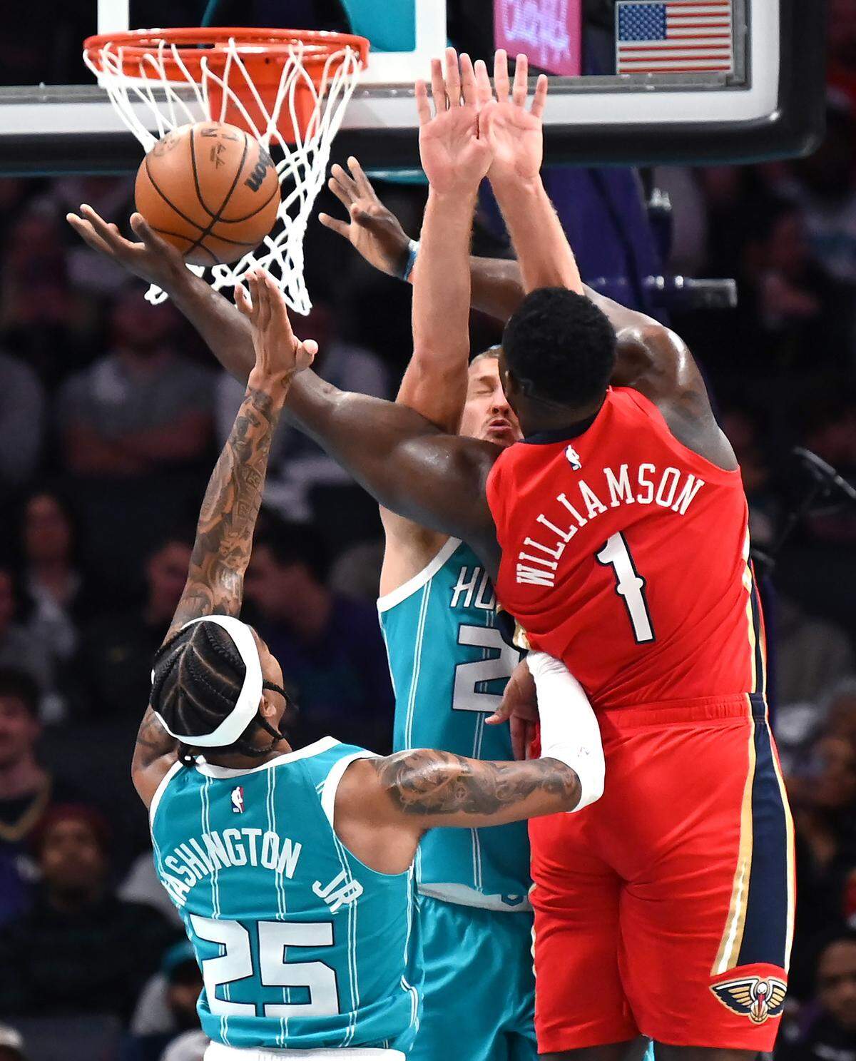 Charlotte Hornets center Mason Plumlee, center and forward PJ Washington, left, attempt to stop New Orleans Pelicans forward Zion Williamson on a drive to the basket during second half action on Friday, October 21, 2022 at Spectrum Center in Charlotte, NC.