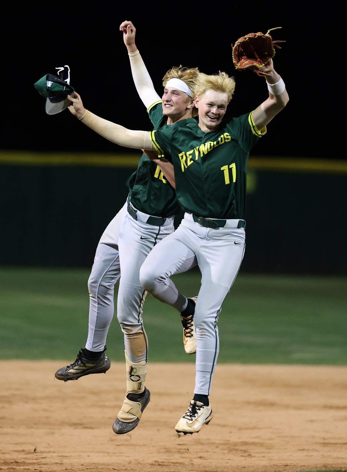 AC Reynolds’ Cody Hudgins, left and Levi Anderson, right, celebrate the team’s 5-4 victory over the Charlotte Catholic Cougars during third round NCHSAA action at Jack Hughes Park in Pineville, NC on Tuesday, May 12, 2026. 
