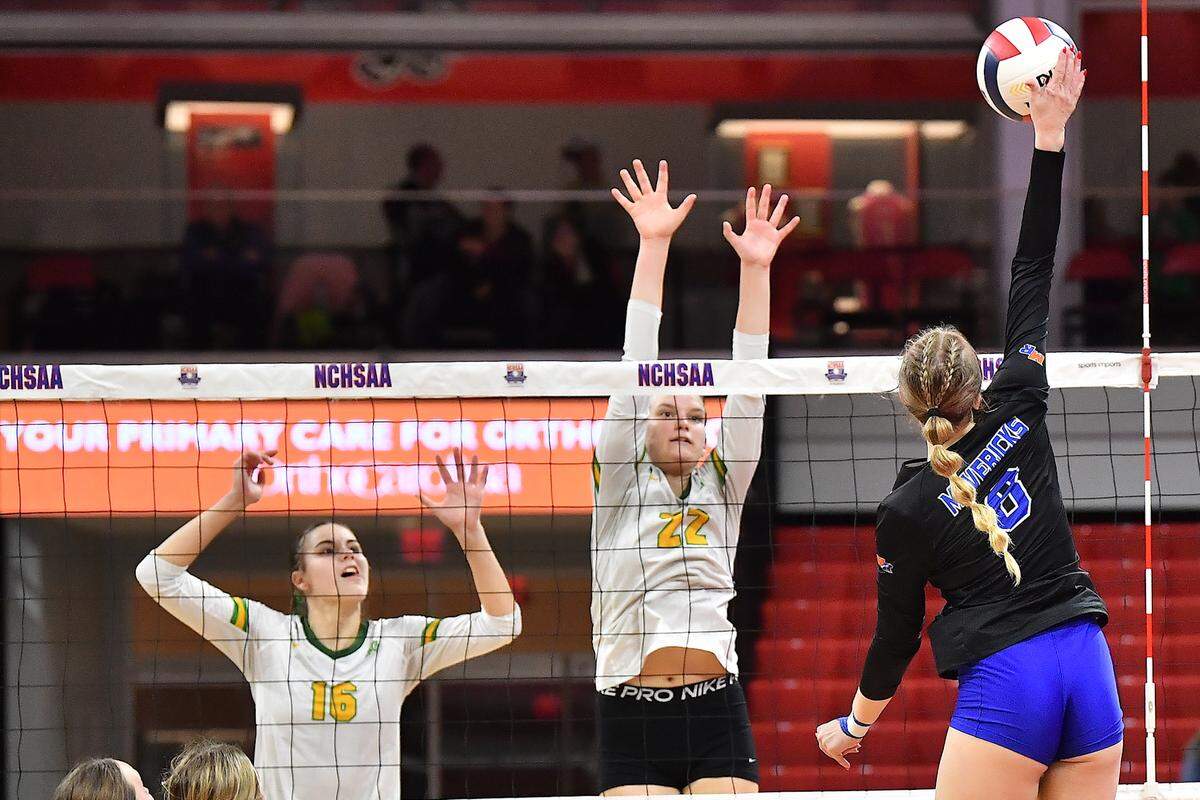 Marvin Ridge’s Ashley Murray (8) spikes the ball against Cardinal Gibbons’ Mary Grace Gonyeau (22) and Amelia Bell (16) in the 2024 NCHSAA 4A Volleyball Championships. The Marvin Ridge Mavericks took on the Cardinal Gibbons Crusaders in the NCHSAA 4A Volleyball Championship match in Raleigh, N.C. on November 2, 2024.