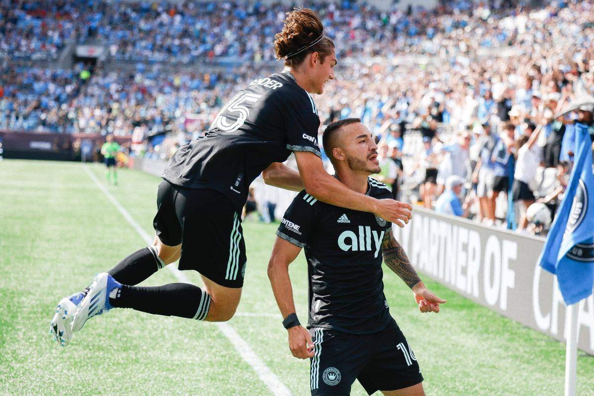 Charlotte FC midfielder Benjamin Bender (15) celebrates a goal with Charlotte FC forward Andre Shinyashiki (16) during a game against the Vancouver Whitecaps at Bank of America Stadium in Charlotte, N.C., Sunday, May 22, 2022.